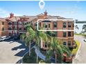 Beautiful condo complex exterior with mature palm trees, vibrant colors and scenic location in Clearwater, FL at 2773 Via Cipriani # 1330B, Clearwater, FL 33764