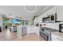 Open-concept kitchen with modern appliances flowing into the living area, perfect for entertaining at 2773 Via Cipriani # 1330B, Clearwater, FL 33764