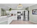 Modern kitchen with stainless steel appliances, white cabinets, and a functional layout for cooking at 2773 Via Cipriani # 1330B, Clearwater, FL 33764