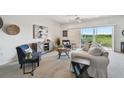 Well-decorated living room with comfortable seating, tasteful artwork, and sliding doors leading to a balcony with outdoor views at 31 Estuary Trl, Clearwater, FL 33759