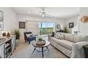 Bright living room with stylish furnishings, neutral colors, and sliding glass doors to a private balcony with scenic views at 31 Estuary Trl, Clearwater, FL 33759