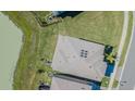 Birds eye view of a home, featuring a geometrically patterned roof and green grass at 32684 Tamarind Grove Ln, Wesley Chapel, FL 33543