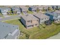 A high angle view of the back of the house showing the roof and the surrounding neighborhood at 32684 Tamarind Grove Ln, Wesley Chapel, FL 33543