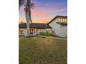 Charming two-story home with manicured lawn, black trim windows, and lush landscaping at 4588 Baycedar Ln, Sarasota, FL 34241