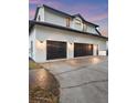 Spacious two-car garage with dark doors and modern exterior lighting at 4588 Baycedar Ln, Sarasota, FL 34241