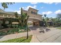 Grand entrance to Harbour Place City Homes with lush greenery and architectural details at 501 Knights Run Ave # 2101, Tampa, FL 33602