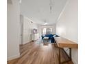 Bright living room with modern decor, hardwood floors, and sliding glass doors to a balcony at 501 Knights Run Ave # 2101, Tampa, FL 33602