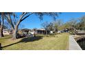 Backyard view with grassy lawn along the water at 5822 River Rd, New Port Richey, FL 34652