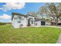 Attractive one-story home featuring a well-maintained lawn and an attached garage at 6140 Silver Oaks Dr, Zephyrhills, FL 33542