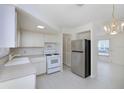 Bright kitchen with modern appliances, including a stainless-steel refrigerator and a gas range at 7847 39Th N Ter, St Petersburg, FL 33709