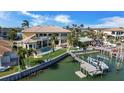 Gorgeous waterfront property featuring a private boat dock, a swimming pool, and lush landscaping at 7986 9Th S Ave, St Petersburg, FL 33707