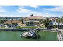 Beautiful waterfront home with a private boat dock, a swimming pool, and an expansive patio area at 7986 9Th S Ave, St Petersburg, FL 33707