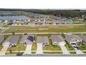 Spacious suburban neighborhood with manicured lawns, a scenic pond, and organized street layouts at 8034 Broad Pointe Dr, Zephyrhills, FL 33540