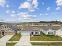 Aerial view of a neighborhood featuring well-maintained homes with manicured lawns and tree lined streets at 8034 Broad Pointe Dr, Zephyrhills, FL 33540