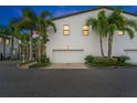 Exterior view of a modern home featuring a two-car garage and lush landscaping at 1110 25Th N St, St Petersburg, FL 33713