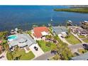 Scenic aerial view of waterfront homes with boat docks, palm trees, and peaceful water views, perfect for boating at 119 Carlyle Cir, Palm Harbor, FL 34683