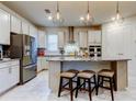Bright kitchen features a center island with seating, stainless steel appliances, and ample counter space at 12704 Palapa Loop, Spring Hill, FL 34610
