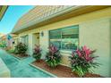 Charming exterior view featuring manicured landscaping, an American flag, and a well-maintained facade at 19029 Us Highway 19 N # 29E, Clearwater, FL 33764