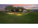 A beautiful home on a sprawling lot, lit by the evening sun at 2102 W Knights Griffin Rd, Plant City, FL 33565