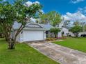 Inviting single-story home with a driveway, attached garage, and well-kept lawn at 2745 Horseshoe Dr, Plant City, FL 33566