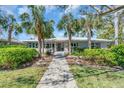 Inviting home with a well-manicured lawn, mature landscaping, and a welcoming pathway leading to the front entrance at 276 Snell Isle Ne Blvd, St Petersburg, FL 33704