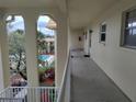 Hallway showcasing the outdoor pool and tropical landscaping through arched openings at 3850 13Th N Ave # 311, St Petersburg, FL 33713