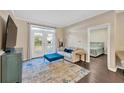 Open living room featuring french doors, modern furniture, and decorative rug at 4221 W Spruce St # 1123, Tampa, FL 33607