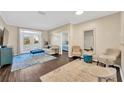 Living room with hardwood floors, stylish furniture, and french doors to the balcony at 4221 W Spruce St # 1123, Tampa, FL 33607