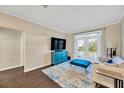 Bright living room with stylish furniture, hardwood floors, and french doors at 4221 W Spruce St # 1123, Tampa, FL 33607