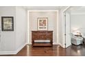 Elegant entryway featuring hardwood floors, detailed wood furniture, and custom wall art at 4857 Tobermory Way, Bradenton, FL 34211
