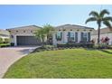 Charming single-story home with a well-manicured lawn and mature landscaping at 4857 Tobermory Way, Bradenton, FL 34211
