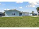 Well-kept single-story home boasts a lush green lawn, a two-car garage, and an extended driveway for extra parking at 5321 Bowline Bnd, New Port Richey, FL 34652