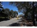 Gated community entrance with mature trees and clear signage for residents and visitors at 8010 Bally Money Rd, Tampa, FL 33610