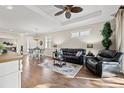 Open-concept living area with hardwood floors, tray ceiling, and stylish furnishings at 8106 Pine Crest St, Seminole, FL 33777