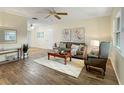 Comfortable living room featuring wood flooring, neutral paint, and a decorative ceiling fan at 9737 36Th N Way, Pinellas Park, FL 33782