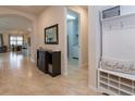 Inviting foyer with tiled floors, coat rack, and entry to living area at 10812 Applewood Range Way, Tampa, FL 33647