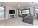 Cozy living room showcasing modern décor, ample natural light, and an entertainment center at 10812 Applewood Range Way, Tampa, FL 33647