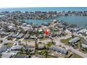 An aerial view shows the beautiful waterfront community with various buildings and calm waters at 14066 Marguerite Dr, Madeira Beach, FL 33708