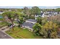 A view of the home's exterior and yard with lush landscaping and mature trees at 1730 Michigan Ne Ave, St Petersburg, FL 33703