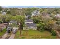 A wide exterior shot shows the home's front yard, driveway, and surrounding mature trees at 1730 Michigan Ne Ave, St Petersburg, FL 33703