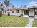 Single-story home exterior showcasing a well-maintained yard and inviting entrance at 18108 Crooked Ln, Lutz, FL 33548