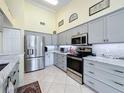 Eat-in kitchen features stainless steel appliances, abundant counter space, and tile flooring at 18504 Water Lily Ln, Hudson, FL 34667