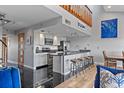 Modern kitchen boasts stainless steel appliances, breakfast bar, and contemporary finishes at 19727 Gulf Blvd # 209, Indian Shores, FL 33785
