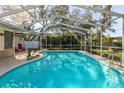 Inviting screened in pool area with clear water, poolside decor, and plenty of space for outdoor relaxation at 2050 Nigels Dr, Dunedin, FL 34698