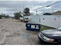 Picture of the street view next to a vacant lot with a dumpster and cars in the shot at 4104 W Osborne Ave, Tampa, FL 33614