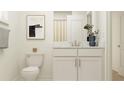 Bright bathroom with white cabinets, framed art, and neutral decor at 4510 S Manhattan Ave # 6, Tampa, FL 33611