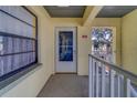 Inviting condo front door with textured walls and large window for natural light at 6033 113Th St # 213, Seminole, FL 33772