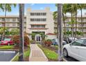 Beautiful five-story condo building featuring lush landscaping and a brick-paved walkway to the entrance at 6083 Bahia Del Mar Cir # 359, St Petersburg, FL 33715