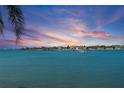 Stunning waterfront view showcases a calm waterway and gorgeous sunset sky overlooking homes in the distance at 6083 Bahia Del Mar Cir # 359, St Petersburg, FL 33715