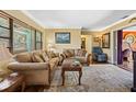 A cozy living room featuring wood floors, a ceiling fan, and natural lighting at 683 Circle E Dr, Largo, FL 33770